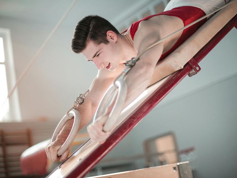Close-up of an athlete's hands gripping a bar, showing texture and determination.