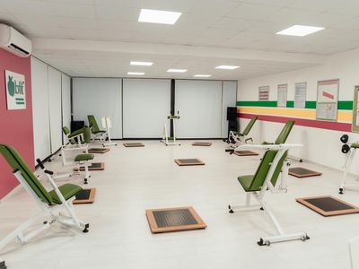 Minimalist training space with natural light and simple equipment.